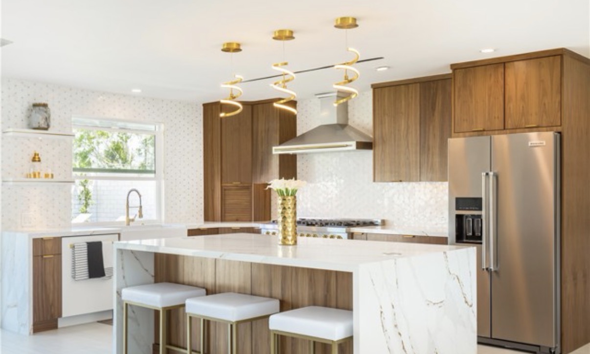 Remodeled kitchen with walnut cabinetry and marble island in Palm Springs, CA